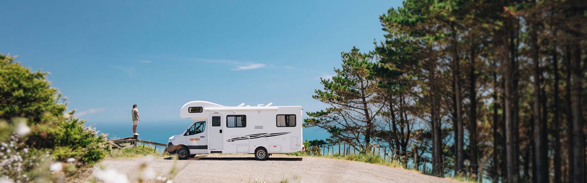 man standing in front of Apollo motorhome in New Zealand