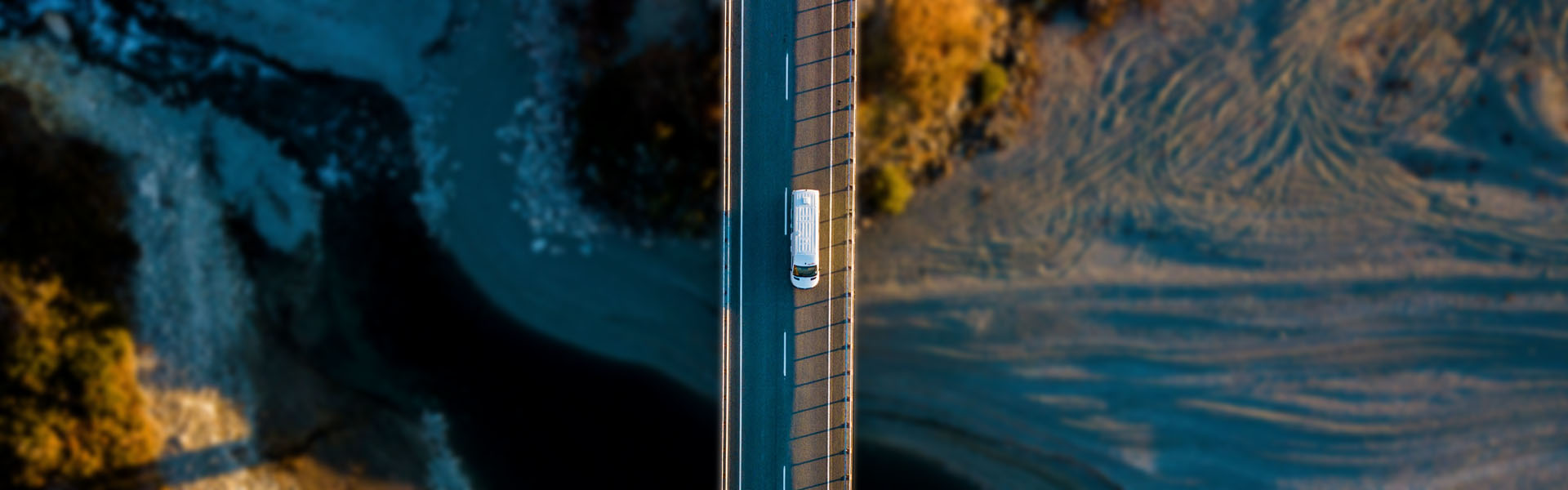 Drone image of Apollo rental campervan driving in New Zealand