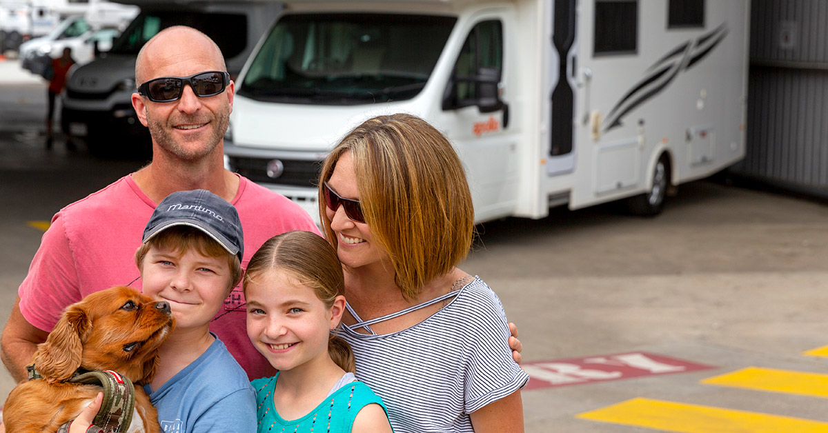 family in front of apollo branch